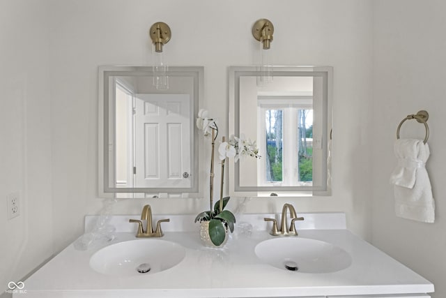 bathroom with a sink and double vanity