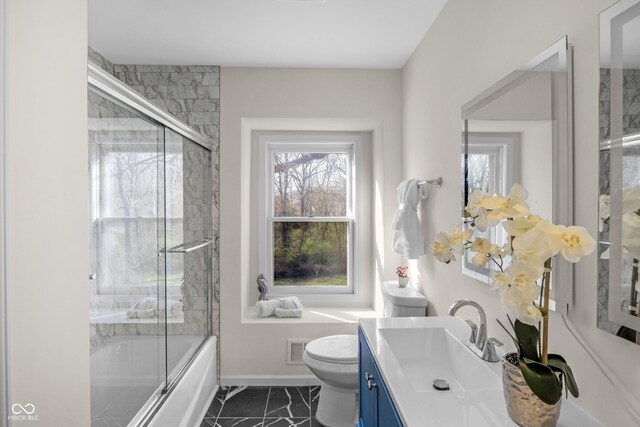 bathroom with visible vents, marble finish floor, vanity, and plenty of natural light