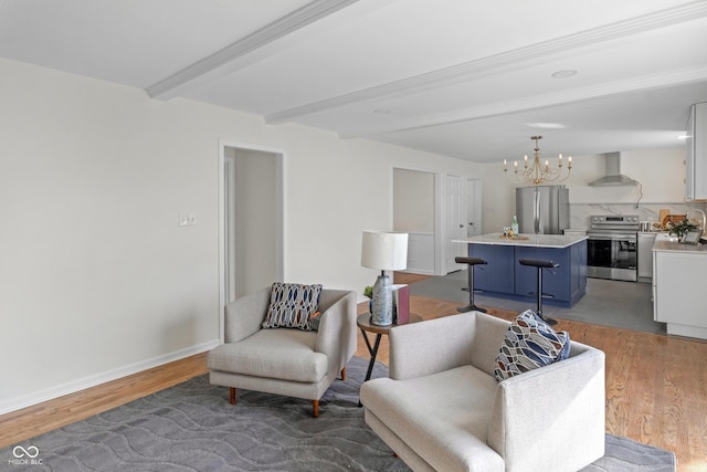 living room with beamed ceiling, baseboards, a notable chandelier, and light wood-style floors