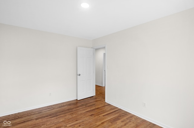 unfurnished room with baseboards, recessed lighting, and wood finished floors