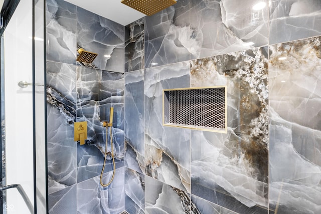 details featuring a marble finish shower