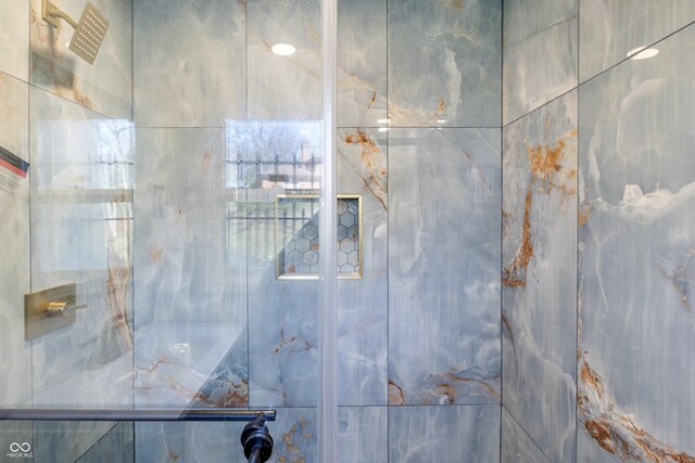 full bath featuring a shower with shower door