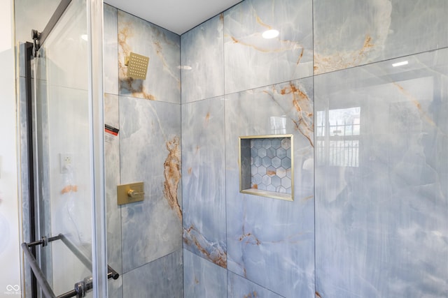 bathroom with a tile shower