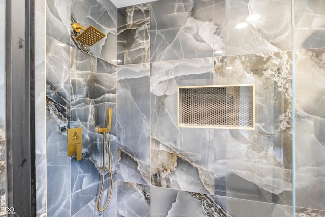 details featuring a marble finish shower