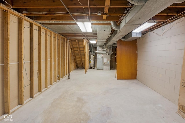 unfinished basement with water heater and heating unit