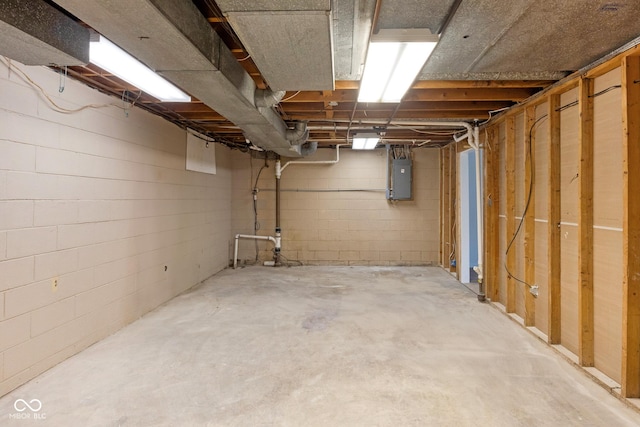 unfinished basement with electric panel and concrete block wall
