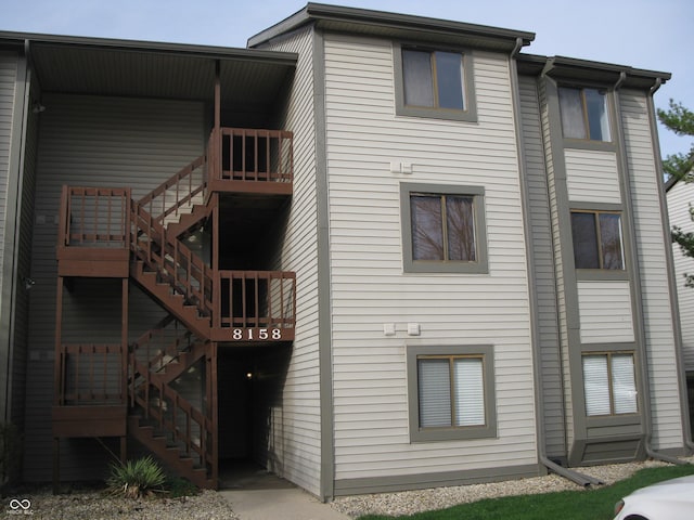 rear view of property featuring stairway