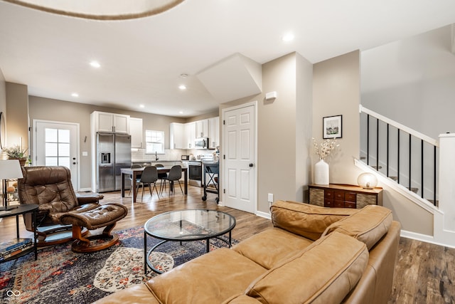 1603 E Market St, Indianapolis, IN 46201 - living area featuring baseboards, recessed lighting, wood finished floors, and stairs