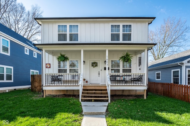 1603 E Market St, Indianapolis, IN 46201 - traditional style home featuring board and batten siding, a front yard, fence, and covered porch