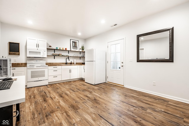 1603 E Market St, Indianapolis, IN 46201 - kitchen with white appliances, light wood-style flooring, open shelves, visible vents, and a sink