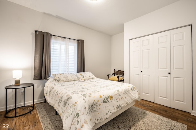 1603 E Market St, Indianapolis, IN 46201 - bedroom featuring a closet, baseboards, and dark wood finished floors