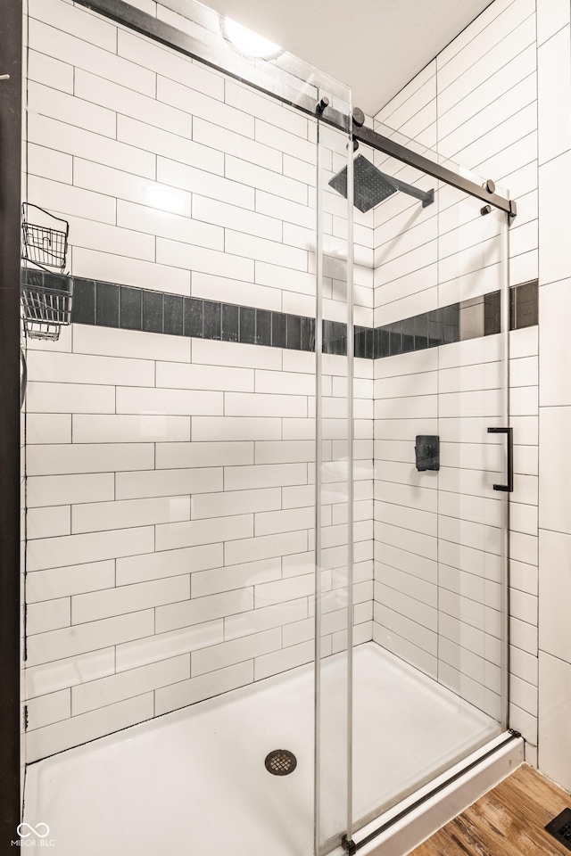 1603 E Market St, Indianapolis, IN 46201 - bathroom featuring a shower stall and wood finished floors