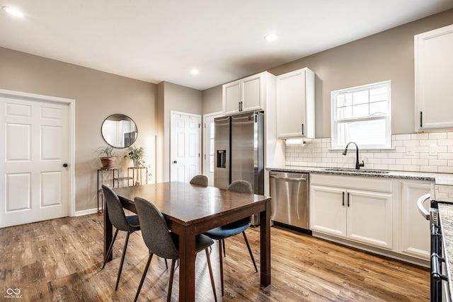 1603 E Market St, Indianapolis, IN 46201 - dining room featuring baseboards, recessed lighting, and light wood-style floors