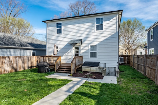 1603 E Market St, Indianapolis, IN 46201 - back of house with central AC unit, a fenced backyard, a wooden deck, and a lawn