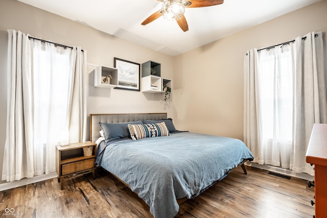 1603 E Market St, Indianapolis, IN 46201 - bedroom with visible vents, multiple windows, a ceiling fan, and wood finished floors