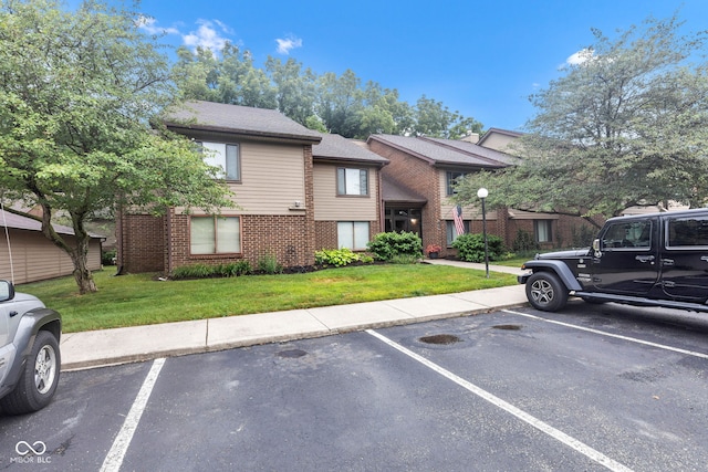 102 Knoll Ct Unit D, Noblesville, IN 46062 - view of front of home featuring brick siding, uncovered parking, and a front lawn