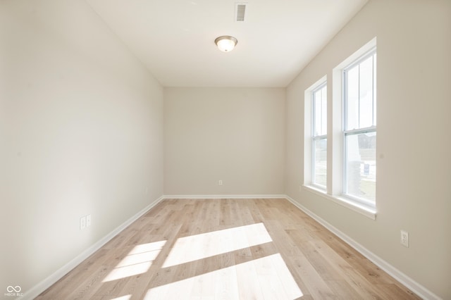 unfurnished room featuring visible vents, baseboards, and light wood-style flooring