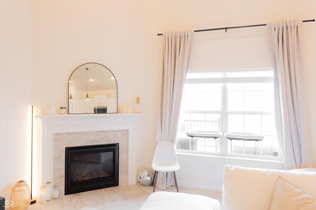 living area featuring a tile fireplace