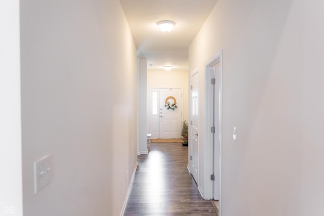 hall with baseboards and dark wood-style floors