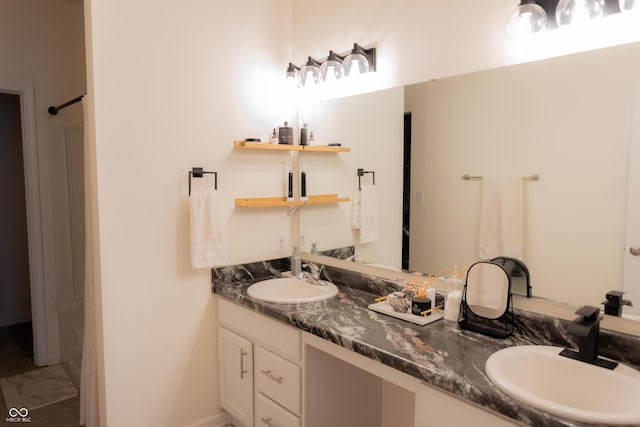 bathroom with double vanity, a sink, and marble finish floor