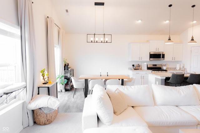 living area featuring an inviting chandelier and light wood-style floors