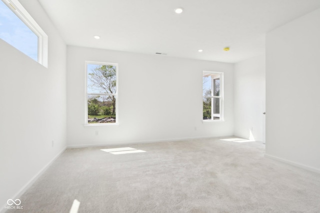carpeted empty room featuring recessed lighting and baseboards