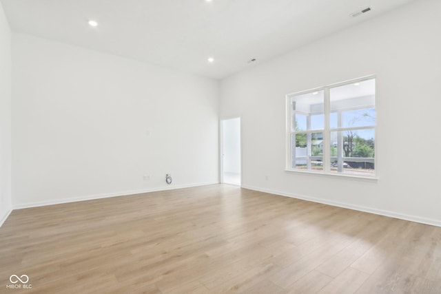 unfurnished room with light wood finished floors, recessed lighting, and baseboards