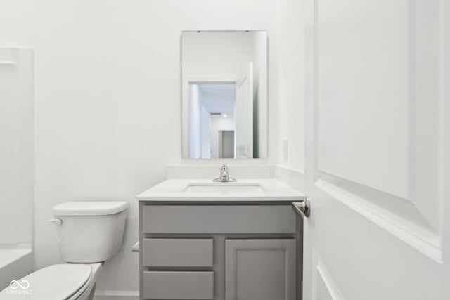 full bathroom with vanity, toilet, and baseboards