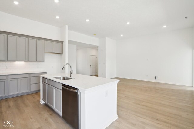 kitchen featuring a sink, stainless steel dishwasher, gray cabinets, light wood finished floors, and recessed lighting