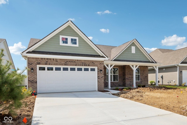 view of front of house with brick siding, a porch, and concrete driveway