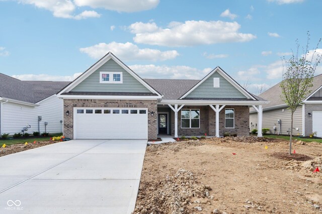view of front facade with brick siding, concrete driveway, and covered porch