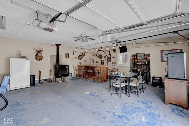 10495 Deer Run Rd, Poland, IN 47868 - garage featuring a garage door opener, a ceiling fan, and freestanding refrigerator