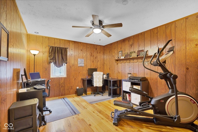 10495 Deer Run Rd, Poland, IN 47868 - exercise room featuring wood finished floors, wood walls, and ceiling fan