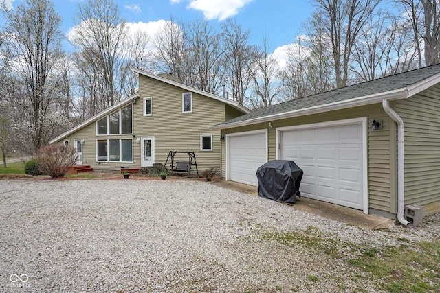 10495 Deer Run Rd, Poland, IN 47868 - rear view of house featuring gravel driveway, a sunroom, and a garage
