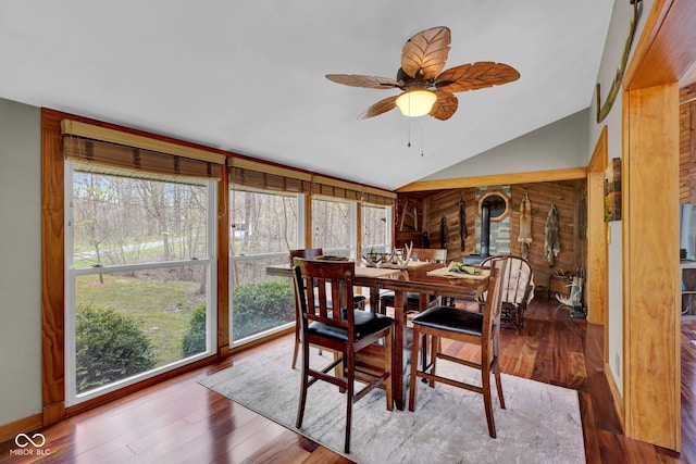 10495 Deer Run Rd, Poland, IN 47868 - dining space featuring lofted ceiling, ceiling fan, wood finished floors, and a wood stove