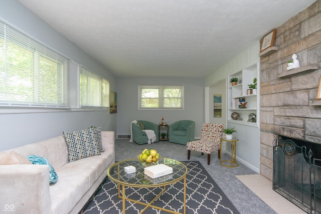 3140 Bonham Dr, Indianapolis, IN 46222 - living area with carpet flooring, a fireplace, a textured ceiling, baseboards, and built in shelves