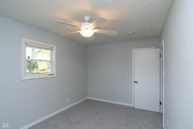 3140 Bonham Dr, Indianapolis, IN 46222 - spare room featuring carpet floors, a ceiling fan, baseboards, and a smoke detector