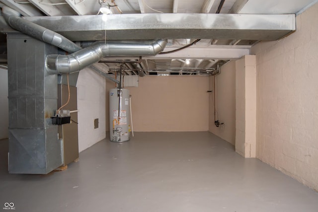 3140 Bonham Dr, Indianapolis, IN 46222 - unfinished below grade area featuring gas water heater, concrete block wall, and heating unit