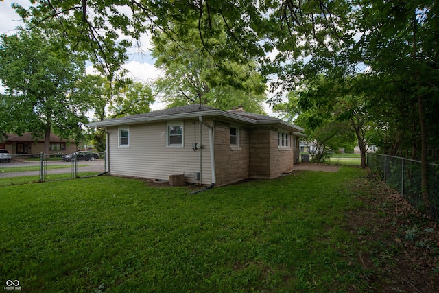3140 Bonham Dr, Indianapolis, IN 46222 - view of side of home featuring a chimney, stone siding, and a gate