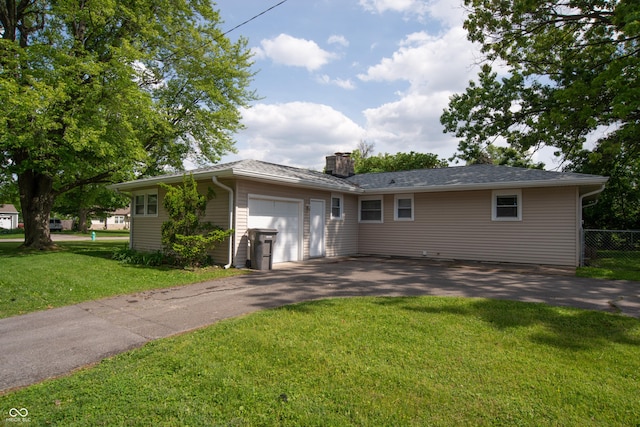 3140 Bonham Dr, Indianapolis, IN 46222 - ranch-style home with asphalt driveway, a garage, and a chimney
