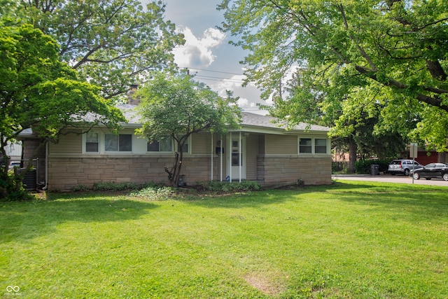 3140 Bonham Dr, Indianapolis, IN 46222 - rear view of property featuring stone siding and a yard