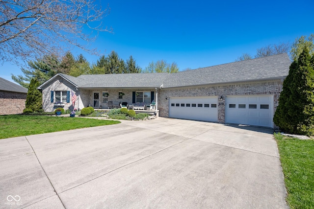 ranch-style home with a front lawn, concrete driveway, covered porch, brick siding, and a garage