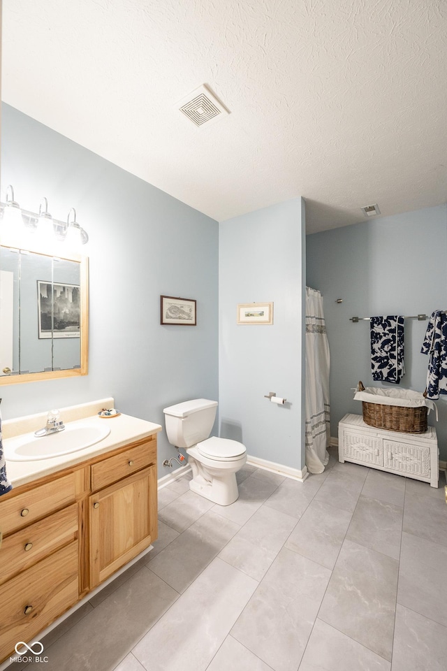 bathroom featuring toilet, vanity, a textured ceiling, and visible vents