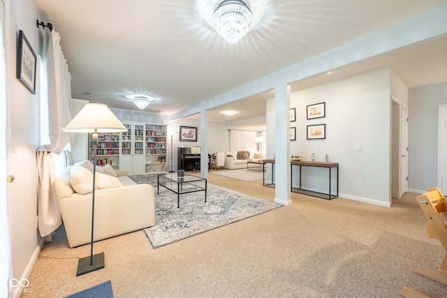 carpeted living area featuring baseboards and a fireplace