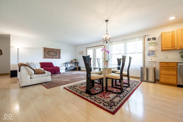 dining space featuring recessed lighting, light wood-style flooring, baseboards, and a notable chandelier