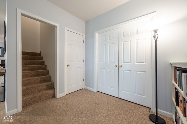 interior space with carpet floors and baseboards