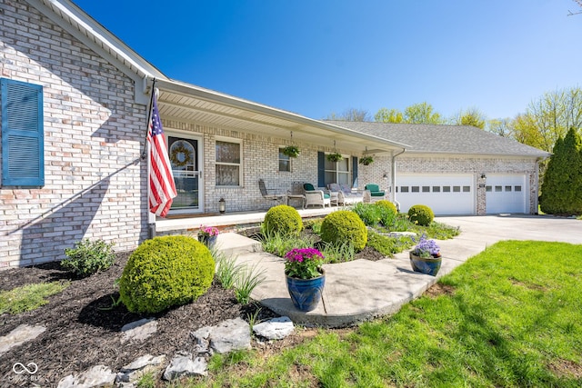 ranch-style home with brick siding, an attached garage, a porch, and concrete driveway