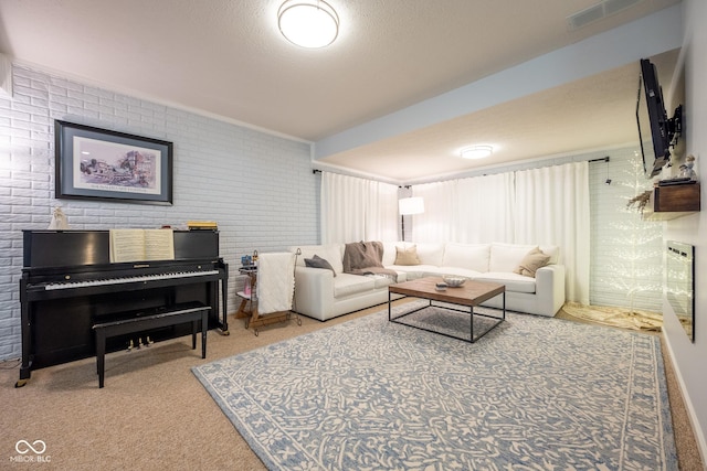 living room featuring brick wall, visible vents, and carpet