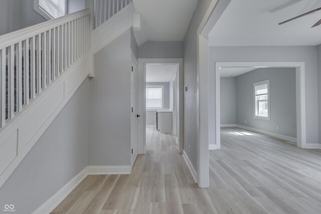 interior space featuring baseboards and light wood finished floors