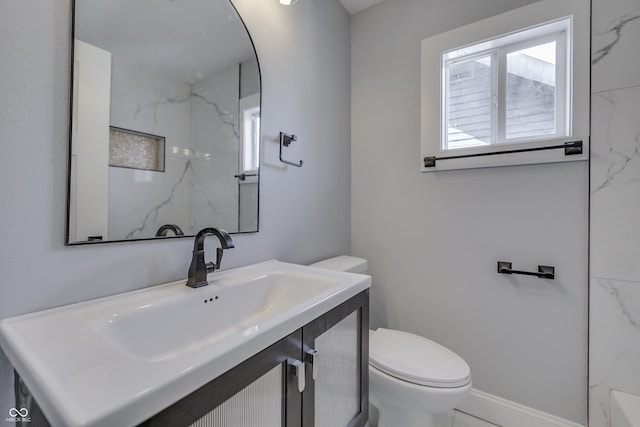 bathroom with vanity, marble finish floor, and toilet